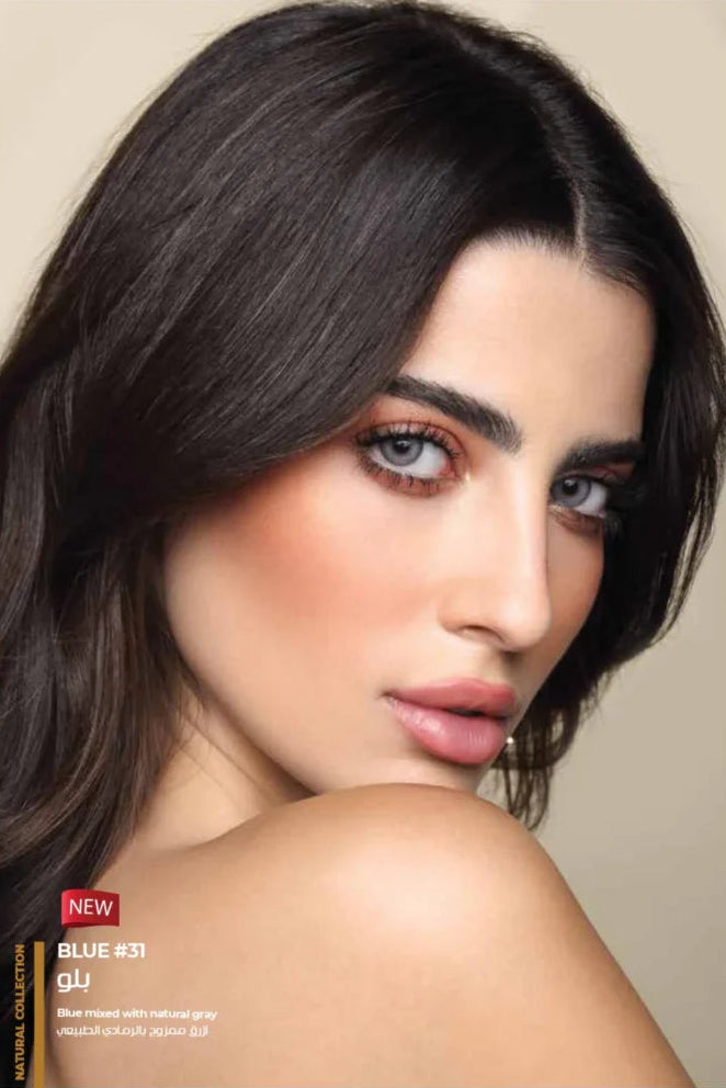 Woman with dark hair and makeup, with a beige background